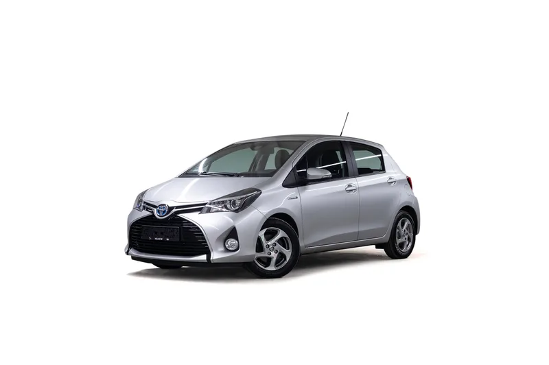 Sølvfarget Toyota Yaris Hybrid fotografert skrått forfra på hvit bakgrunn